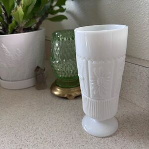 Elegant milk glass footed bud vase. Approx 7” tall